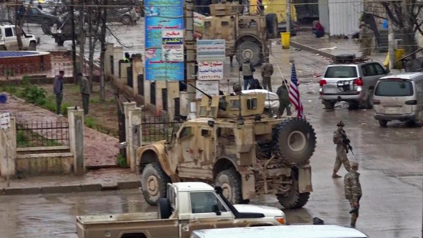 An image grab taken from a video obtained by AFPTV on January 16, 2019, shows US troops gathered at the scene of a suicide attack in the northern Syrian town of Manbij. - A suicide attack targeting US-led coalition forces in the flashpoint northern Syrian city of Manbij killed a US serviceman and 14 other people today, a monitor said. (Photo by - / various sources / AFP)        (Photo credit should read -/AFP/Getty Images)