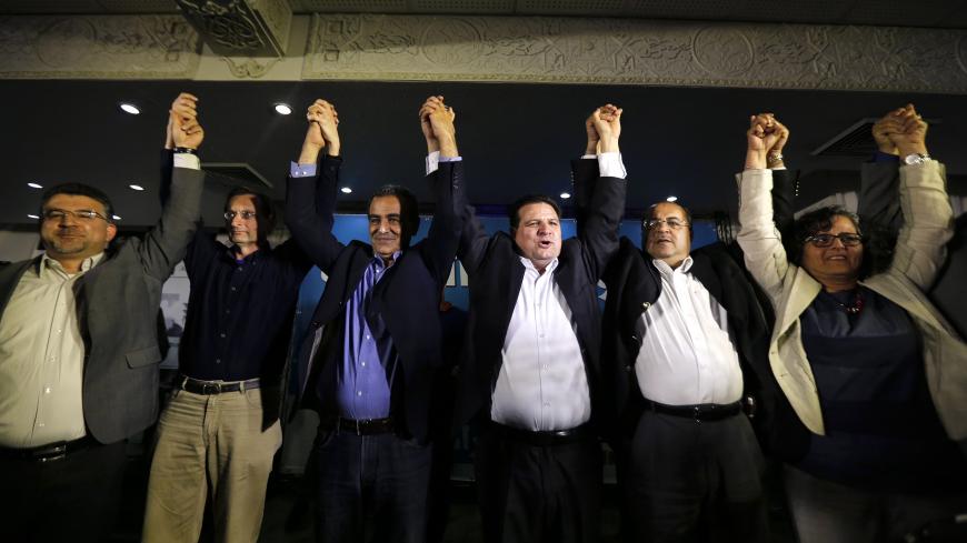 Ayman Odeh (3rd R), head of the Joint Arab List, reacts with members of the party after exit poll results in Nazareth March 17, 2015. Prime Minister Benjamin Netanyahu closed a gap with center-left rival Isaac Herzog in a hard-fought Israeli election on Tuesday, exit polls showed, leaving both men with a chance to rule but Netanyahu with the clearer path to forming a coalition. But Herzog also could prevail, should Kulanu and a bloc of Arab Israelis - which the polls predicted would be Israel's third larges
