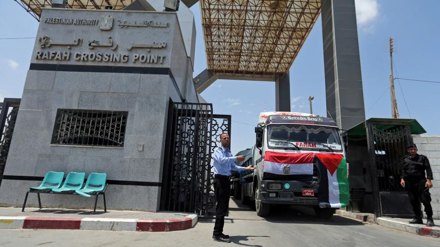 Palestinian policemen loyal to Hamas stand guard as fuel tankers enter Gaza through the Rafah border between Egypt and southern Gaza Strip June 21, 2017. REUTERS/Ibraheem Abu Mustafa - RC12075B1A70