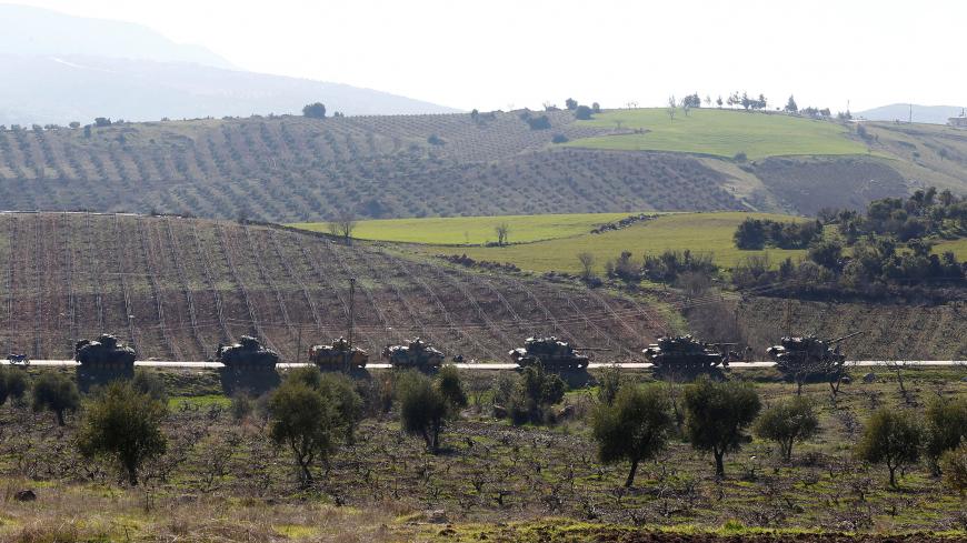 Turkish Army tanks and armoured personnel carriers are seen near the Turkish-Syrian border in Kilis province, Turkey January 31, 2018. REUTERS/Osman Orsal - RC18F29DD730