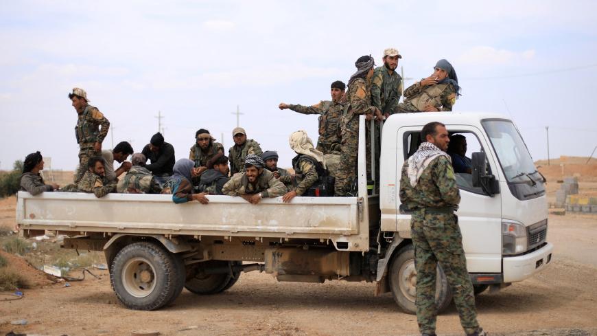 Fighters of Syrian Democratic Forces (SDF) sit at the back of a truck in Deir al-Zor, Syria May 1, 2018. REUTERS/Rodi Said - RC1BB08864D0
