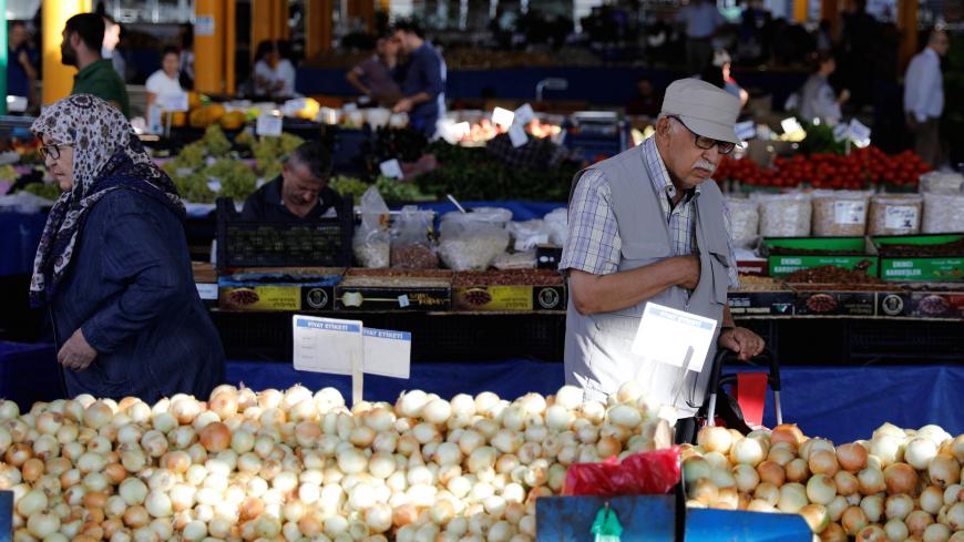 People buy vegetables at a bazaar in Ankara, Turkey August 16, 2018. REUTERS/Umit Bektas - RC1C13720540
