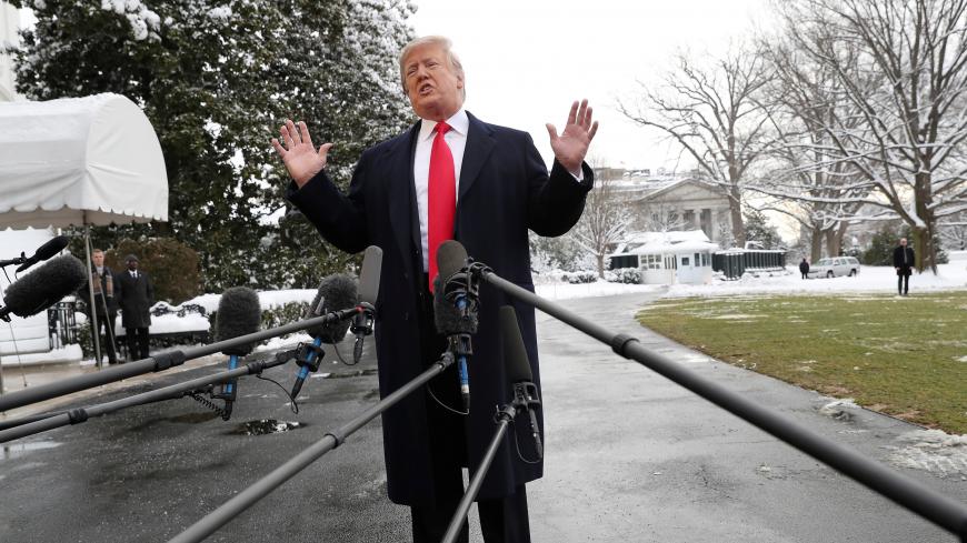 U.S. President Donald Trump speaks to the news media before boarding Marine One to depart for travel to New Orleans from the South Lawn of the White House in Washington, U.S., January 14, 2019. REUTERS/Leah Millis - RC196A2425C0