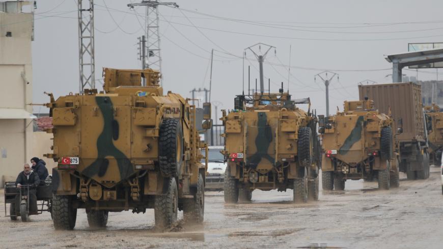 Turkish military vehicles ride at the Bab el-Salam border crossing between the Syrian town of Azaz and the Turkish town of Kilis, in Syria January 1, 2019. Picture taken January 1, 2019. REUTERS/Khalil Ashawi - RC1AD1B9E6A0