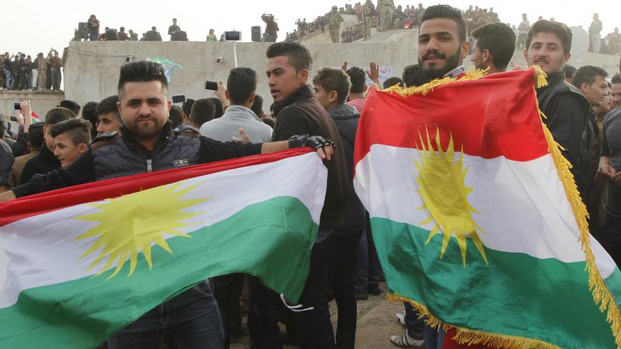 Kurdish residents hold flags during Norouz celebrations in Kirkuk, north of Baghdad March 20, 2016. REUTERS/Ako Rasheed  - GF10000353437