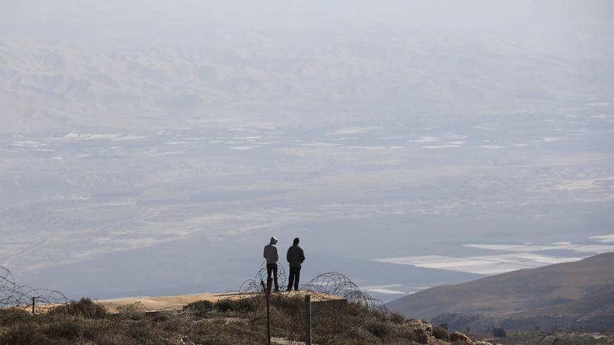 Jewish settlers stand at an observation point overlooking the West Bank village of Duma, near Yishuv Hadaat, an unauthorised Jewish settler outpost January 5, 2016. Steeped in messianic Jewish mysticism and rebelling against what they see as adulterated modern Zionism, the "Hilltop Youth," a new generation of ultra-religious settlers whose resentment of the secular Israeli state rivals their hostility toward Arabs, number in the hundreds, by most accounts. But they pose a deep-rooted challenge even for the 