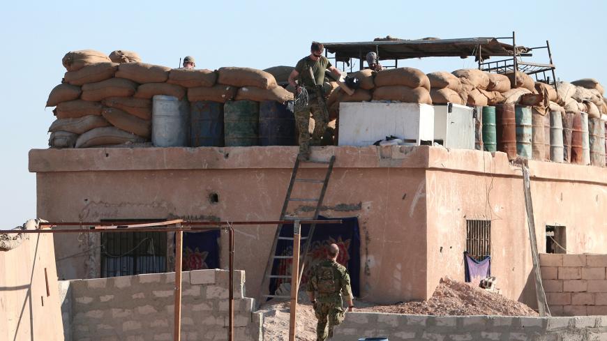 A U.S. fighter walks down a ladder from a barricade, north of Raqqa city, Syria November 6, 2016. REUTERS/Rodi Said - S1AEULHGDXAA