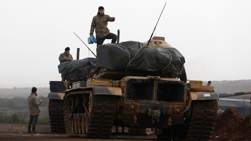 Turkish soldiers stand on top of tanks in a village on the Turkish-Syrian border in Gaziantep province, Turkey January 22, 2018. REUTERS/Osman Orsal - RC17A2093380