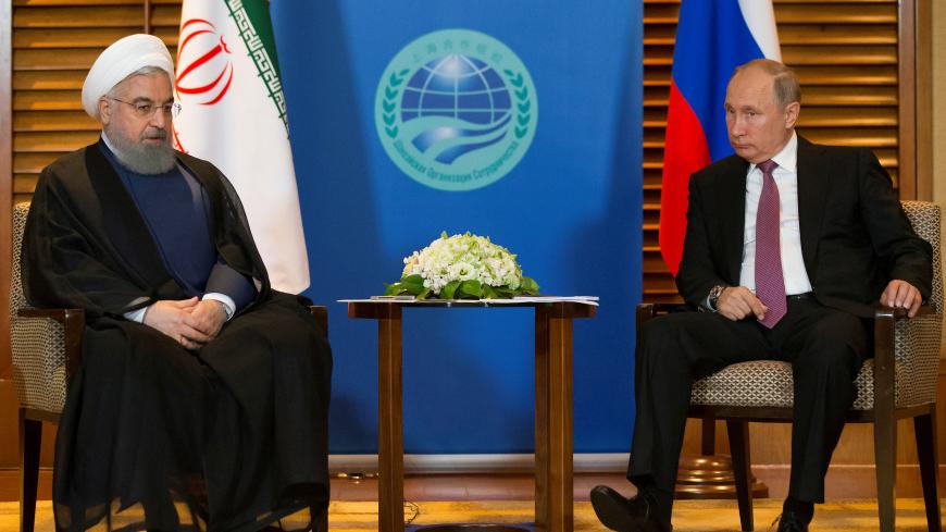 Russian President Vladimir Putin (R) meets with Iranian President Hassan Rouhani on the sidelines of the Shanghai Cooperation Organisation Summit (SCO) in Qingdao, China June 9, 2018. Alexander Zemlianichenko/Pool via REUTERS - RC1FFD5C2CA0