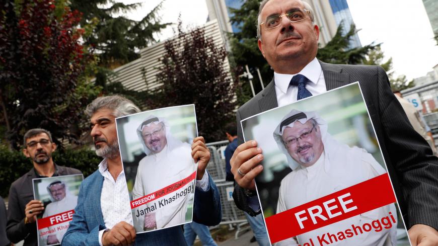 Human rights activists and friends of Saudi journalist Jamal Khashoggi hold his pictures during a protest outside the Saudi Consulate in Istanbul, Turkey October 8, 2018. REUTERS/Murad Sezer - RC1E12753350
