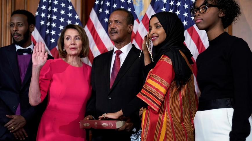 Rep. Ilhan Omar (D-MN) poses with Speaker of the House Nancy Pelosi (D-CA) for a ceremonial ceremonial swearing in picture on Capitol Hill in Washington, U.S., January 3, 2019.      REUTERS/Joshua Roberts - RC1A408A84A0