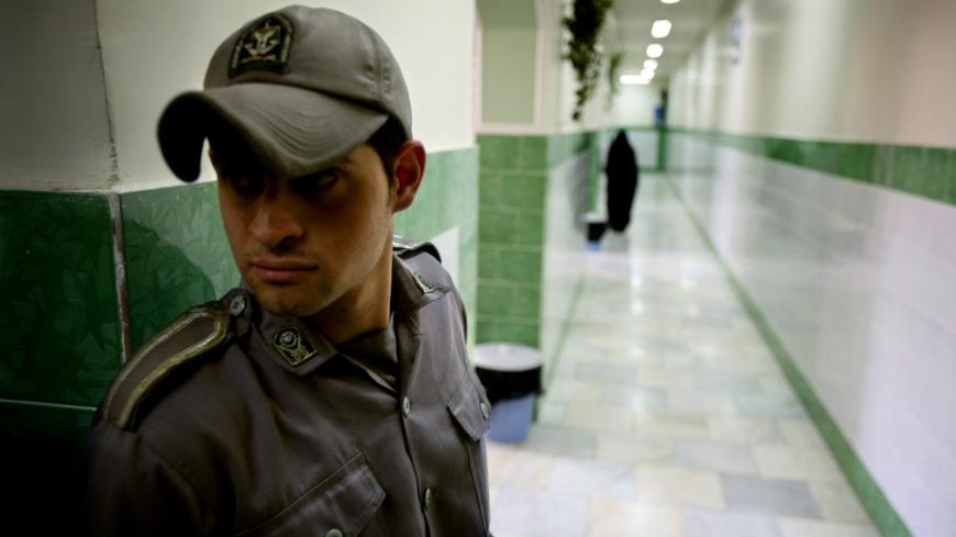 A prison guard stands along a corridor in Tehran's Evin prison June 13, 2006. Iranian police detained 70 people at a demonstration in favour of women's rights, the judiciary said on Tuesday, adding it was ready to review reports that the police had beaten some demonstrators. - PBEAHUNMBAM