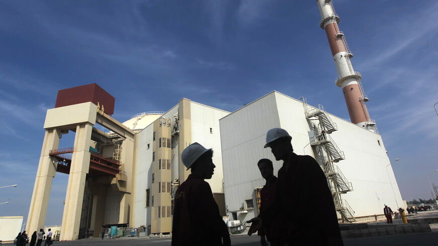 Iranian workers stand in front of the Bushehr nuclear power plant, about 1,200 km (746 miles) south of Tehran October 26, 2010. Iran has begun loading fuel into the core of its first nuclear power plant on Tuesday, one of the last steps to realising its stated goal of becoming a peaceful nuclear power, state-run Press TV reported on Tuesday. REUTERS/Mehr News Agency/Majid Asgaripour (IRAN - Tags: POLITICS ENERGY IMAGES OF THE DAY) - GM1E6AQ1G1401