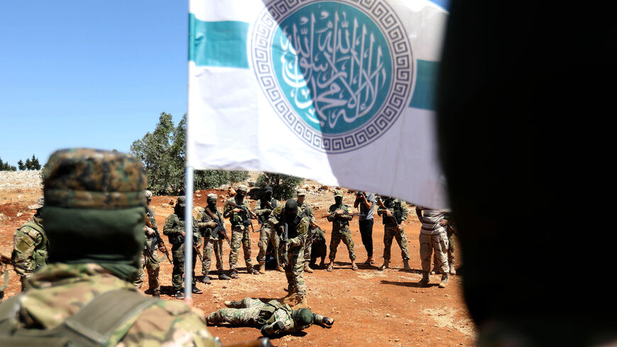Syrian fighters fight as they attend a mock battle in anticipation of an attack by the regime on Idlib province and the surrounding countryside, during a graduation of new Hayat Tahrir al-Sham (HTS) members at a camp in the countryside of the northern Idlib province on August 14, 2018. (Photo by OMAR HAJ KADOUR / AFP)        (Photo credit should read OMAR HAJ KADOUR/AFP/Getty Images)