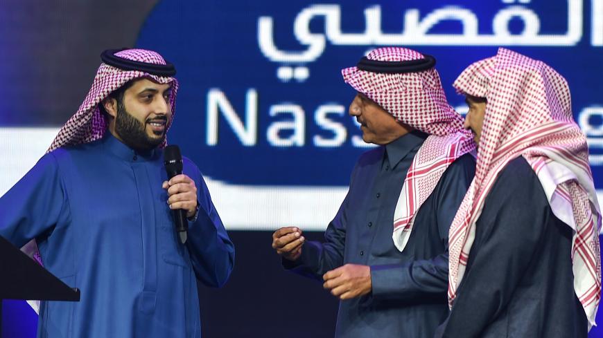 Turki Al-Sheikh (L), the new CEO of Saudi Arabia's General Entertaintment Authority (GEA), speaks as he stands on the stage next to Saudi actors, during a presentation of the 2019 GEA program at the Four Seasons hotel in Riyadh on January 22, 2019. (Photo by FAYEZ NURELDINE / AFP)        (Photo credit should read FAYEZ NURELDINE/AFP/Getty Images)