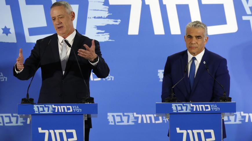 Newly allied Israeli centrist politicians, Benny Gantz (L) a former armed forces chief of staff, and Yair Lapid, deliver a joint statement in the coastal city of Tel Aviv on February 21, 2019, ahead of the April 9 general election. - The two main challengers to Israeli Prime Minister Benjamin Netanyahu announced an electoral alliance today, posing a threat to the premier's long tenure in office as he also faces potential corruption charges. (Photo by Jack GUEZ / AFP)        (Photo credit should read JACK GU