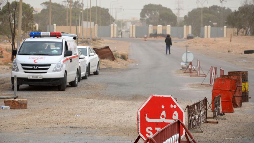 A picture taken on March 22, 2016 shows vehicles waiting near the Tunisian customs post at the Ras Jedir border crossing with Libya, south of the town of Ben Guerdane, after it was reopened after a two-week closure in response to a deadly jihadist attack on a town near the frontier. 
Both the Ras Jedir crossing on the Mediterranean coast and the Dehiba crossing in the mountainous desert interior reopened at 0600 GMT, ministry spokesman Yasser Mesbah said.Tunisia closed the two crossings on March 7 when doze