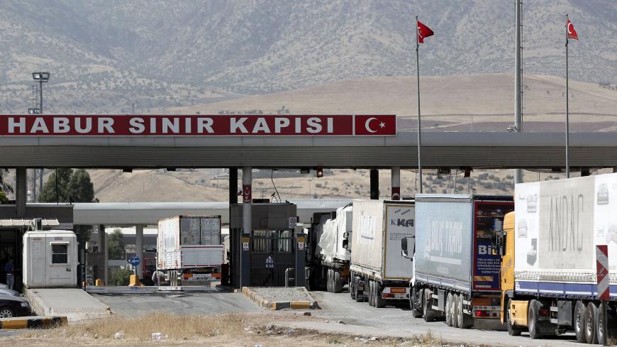 Trucks line up at Turkey's Habur border gate to Iraq July 6, 2014. Chaos in Iraq, where an Islamist insurgency threatens to dismember the country, has brought one of Turkey's key trade routes to a virtual halt. Turkish exports to Iraq fell 21 percent to $727 million in June, according to data from the Turkish Exporters Association (TIM), but the full extent of the drop-off in trade is only likely to be reflected in the figures over the coming months. Picture taken July 6, 2014.   REUTERS/Osman Orsal (TURKEY