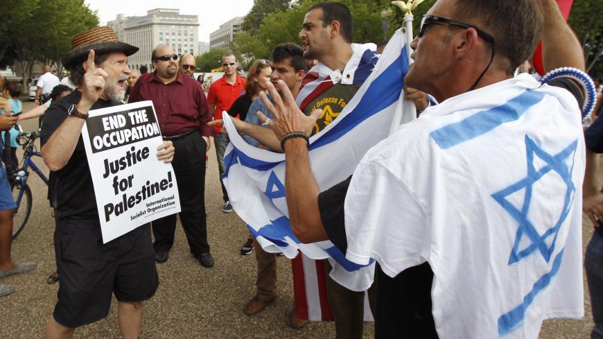 Pro-Palestinian and pro-Israel protesters argue during their rally outside the White House in Washington August 9, 2014. Israel launched more than 30 air attacks in Gaza on Saturday, killing five Palestinians, and militants fired rockets at Israel as the conflict entered a second month, defying international efforts to revive a ceasefire. REUTERS/Yuri Gripas (UNITED STATES - Tags: POLITICS CIVIL UNREST) - GM1EA8A09NC01