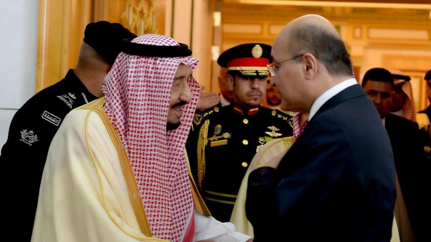 Saudi Arabia's King Salman bin Abdulaziz Al Saud shake hands with Iraq's President Barham Salih during his visit in Riyadh, Saudi Arabia, November 18, 2018. The Presidency of the Republic of Iraq Office/Handout via REUTERS   ATTENTION EDITORS - THIS IMAGE WAS PROVIDED BY A THIRD PARTY. - RC1650B939B0