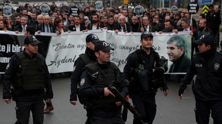 Riot police lead a group of lawyers gathering in Sur district to commemorate the late Diyarbakir Bar Association President Tahir Elci on the third anniversary of his death from gunshot wounds, in Diyarbakir, Turkey November 28, 2018. REUTERS/Sertac Kayar - RC1666DBA450