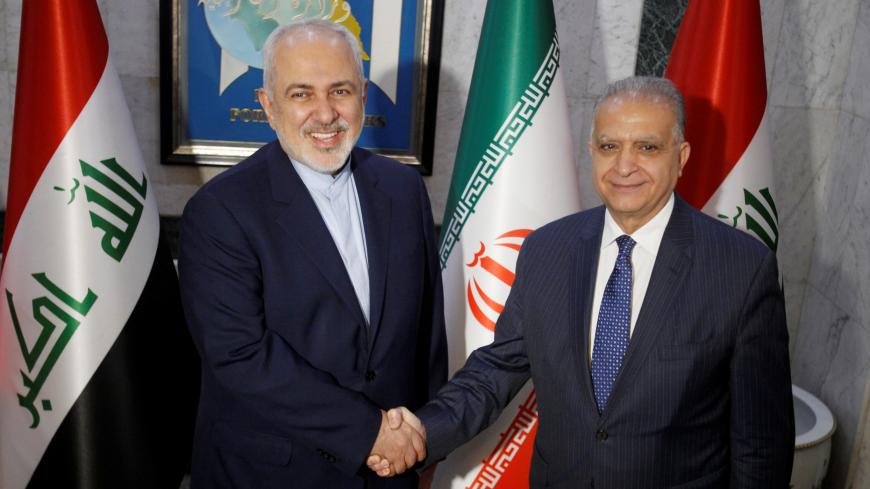 Iranian Foreign Minister Mohammad Javad Zarif shakes hands with his Iraqi counterpart Mohamed Ali Alhakim, in Baghdad, Iraq January 13, 2019. REUTERS/Khalid Al-Mousily - RC1447E53E80
