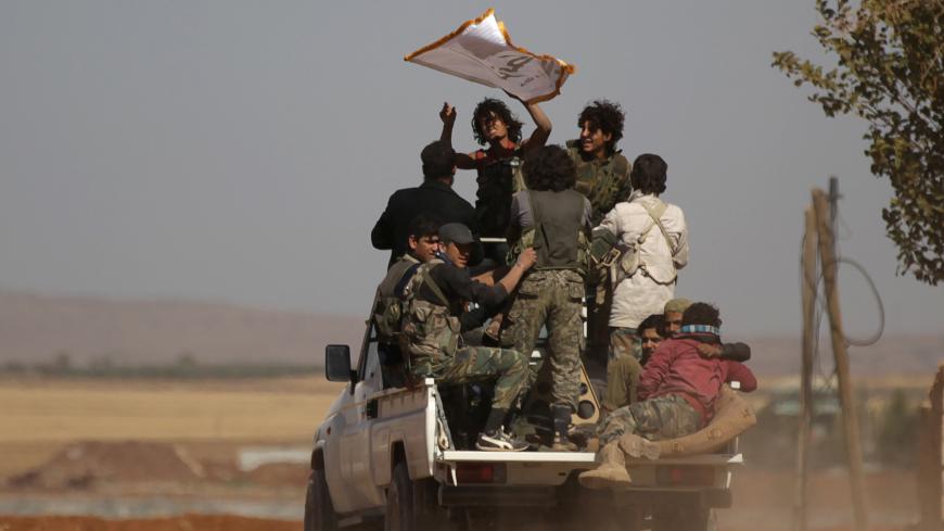 Harakat Nour al-Din al-Zenki fighters ride on a pick-up truck in the northern Syrian rebel-controlled town of al-Rai, in Aleppo Governorate, Syria, September 27, 2016. REUTERS/Khalil Ashawi  - S1BEUDSXXMAA