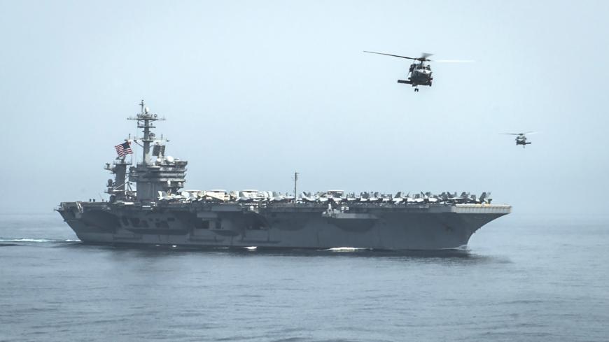 Helicopters fly from the aircraft carrier USS Theodore Roosevelt (CVN 71) during a resupply mission with the aircraft carrier USS Carl Vinson (CVN 70) in this U.S. Navy handout picture taken in the Gulf of Oman April 13, 2015 and released April 20, 2015. The U.S. Navy sent the carrier USS Theodore Roosevelt and its escort cruiser, USS Normandy, from the Gulf into the Arabian Sea on Sunday.  Army Colonel Steve Warren, a Pentagon spokesman, denied reports the ships were on a mission to intercept Iranian arms 