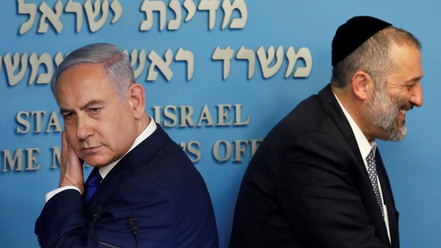 Israeli Prime Minister Benjamin Netanyahu and Israeli Interior Minister Aryeh Deri are seen at the end of a news conference at the Prime Minister's office in Jerusalem April 2, 2018. REUTERS/Ronen Zvulun - RC163EB70890