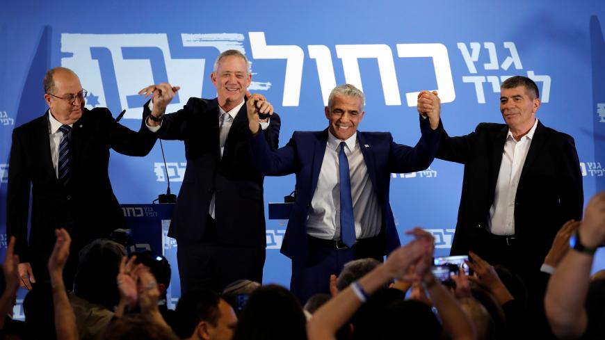Benny Gantz, head of Resilience party and Yair Lapid, head of Yesh Atid, Moshe Yaalon and Gaby Ashkenazy react at the end of a news conference to announce the formation of their joint party, following an alliance between their parties, in Tel Aviv, Israel February 21, 2019. REUTERS/Amir Cohen - RC1A010F8720