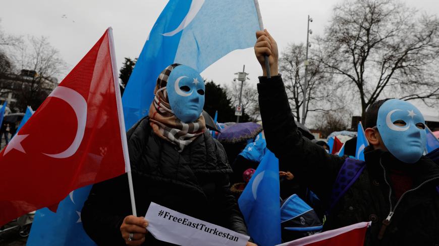 Ethnic Uighur demonstrators hold East Turkestan and Turkish flags during a demonstration against China in Istanbul, Turkey, February 23, 2019. REUTERS/Umit Bektas - RC1BEF41E5B0