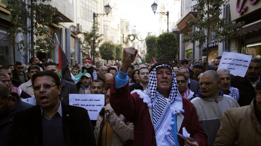 Palestinians march in the streets of the occupied West Bank city of Ramallah, calling for the cessation of divisions between Fatah and Hamas and the unification of the West Bank and Gaza Strip, on January 12, 2019. (Photo by ABBAS MOMANI / AFP)        (Photo credit should read ABBAS MOMANI/AFP/Getty Images)