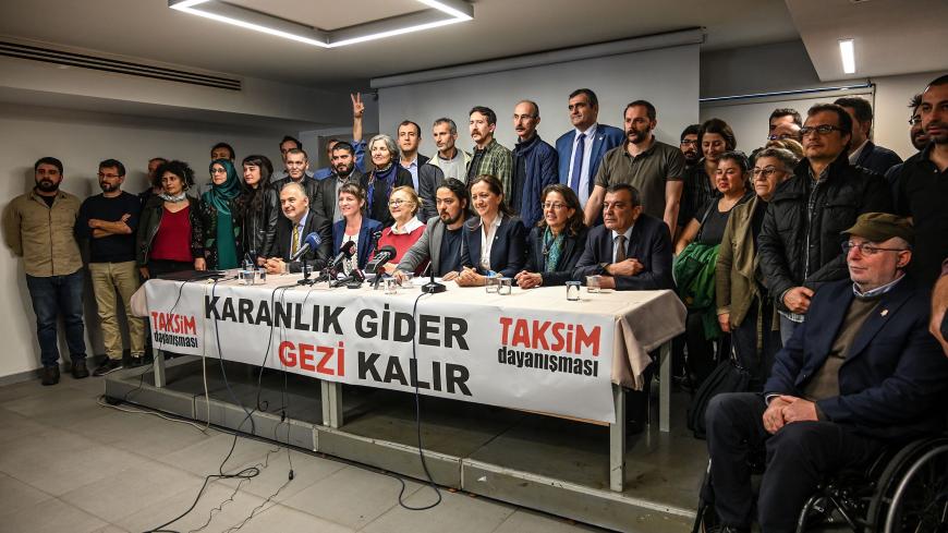Members of Taksim solidarity platform pose in front of a banner reading "Darkness will go, Gezi will stay" on March 11, 2019 during a press conference in Istanbul. - Turkish activists at the forefront of the mass 2013 anti-government protests on March 11, 2019, rejected "irrational" and "unlawful" indictment targeting prominent Turkish businessman Osman Kavala and 15 others. (Photo by Ozan KOSE / AFP)        (Photo credit should read OZAN KOSE/AFP/Getty Images)