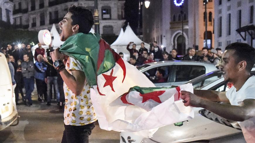 Algerian youths march with national flags during a demonstration in the centre of the capital Algiers on March 11, 2019, after President Abdelaziz Bouteflika announced his withdrawal from a bid to win another term in office and postponed an April 18 election, following weeks of protests against his candidacy. - Bouteflika, in a message carried by national news agency APS, said the presidential poll would follow a national conference on political and constitutional reform to be drawn up by the end of 2019. (