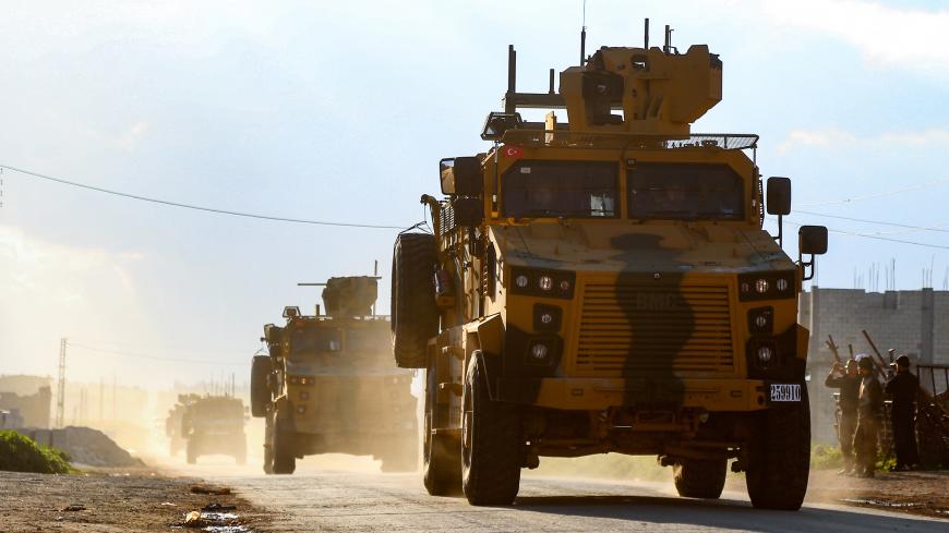 A column of armoured Turkish military vehicles drives along a road in the de-militarised zone in the northwestern Syrian town of Khan Sheikhun on March 17, 2019. - Khan Sheikhun is supposed to be protected by an internationally brokered ceasefire deal, but increased shelling and air strikes by regime forces last month have left its streets near empty. (Photo by - / AFP)        (Photo credit should read -/AFP/Getty Images)