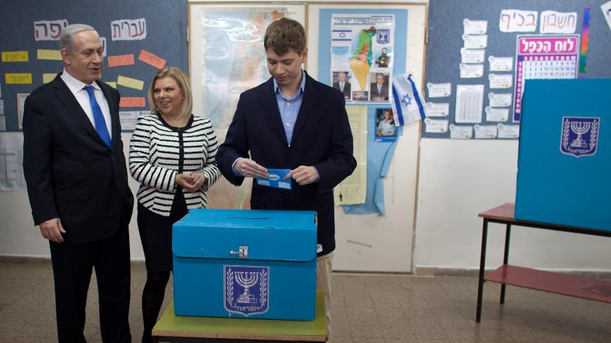 JERUSALEM, ISRAEL - JANUARY 22: (ISRAEL OUT) Israeli Prime Minister Benjamin Netanyahu watches his son Yair Netanyahu cast his ballot with by wife Sara Netanyahu at a polling station on election day on January 22, 2013 in Jerusalem, Israel. Israel's general election voting has begun today as polls show Netanyahu is expected to return to office with a narrow majority. (Photo by Uriel Sinai/Getty Images)