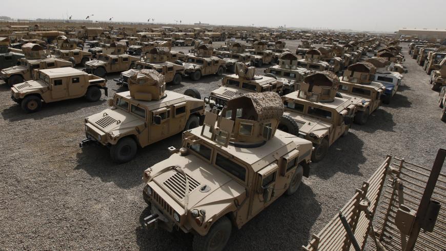 A view of humvees parked at a courtyard at Camp Liberty in Baghdad September 30, 2011. U.S troops are scheduled to pull out of the country by the end of this year, according to a 2008 security pact between the U.S. and Iraq. Picture taken September 30, 2011. REUTERS/Mohammed Ameen (IRAQ - Tags: CONFLICT MILITARY POLITICS) - GM1E7A11FAJ01