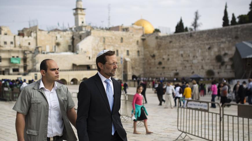 Israeli parliament member from the Likud party Moshe Feiglin (R) walks near the Western Wall after visiting the compound known to Muslims as Noble Sanctuary and to Jews as Temple Mount in Jerusalem's Old City November 2, 2014. Feiglin, a far-right politician who wants Jews to be allowed to pray at Jerusalem's al-Aqsa compound, visited the site on Sunday, defying Prime Minister Benjamin Netanyahu's calls for restraint after clashes this week between Israeli police and Palestinians. REUTERS/Amir Cohen (JERUSA