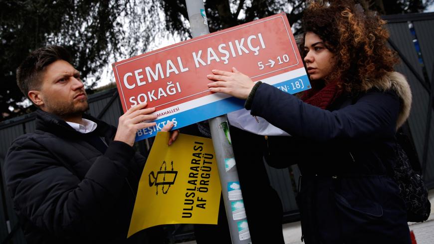 Andrew Gardner, Amnesty International's Turkey Strategy and Research Manager, places a symbolic street sign near the Saudi Arabia's Consulate during a demonstration to mark the 100th day of Saudi journalist Jamal Khashoggi's killing, in Istanbul, Turkey January 10, 2019. REUTERS/Murad Sezer - RC1D6C0210C0