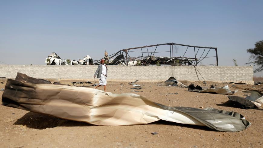 A man walks at the site of an air strike launched by the Saudi-led coalition in the Houthi-held capital Sanaa, Yemen January 20, 2019. REUTERS/Khaled Abdullah - RC158FBC21C0