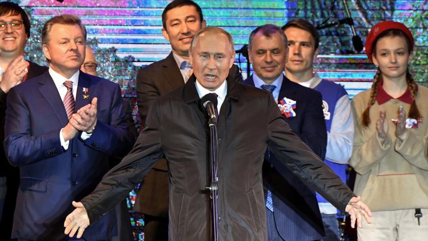 Russian President Vladimir Putin addresses the crowd during a concert marking the fifth anniversary of Russia's annexation of Crimea, in Simferopol March 18, 2019. Yuri Kadobnov/Pool via REUTERS - RC1E8C97C900