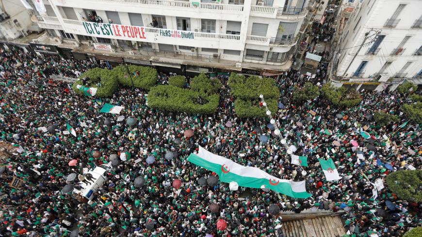 Demonstrators carry Algerian national flags during a protest calling on President Abdelaziz Bouteflika to quit, in Algiers, Algeria March 22, 2019. REUTERS/Zohra Bensemra - RC1B21854090