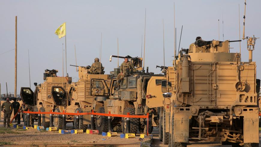 American soldiers stand near military trucks, at al-Omar oil field in Deir Al Zor, Syria March 23, 2019. REUTERS/Rodi Said - RC168E86AEF0