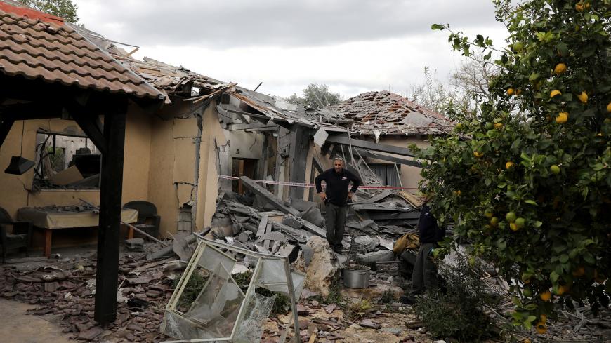 A police sapper inspects a damaged house that was hit by a rocket north of Tel Aviv Israel March 25, 2019. REUTERS/ Ammar Awad - RC1D84B33280