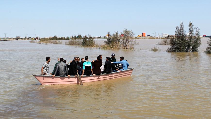 People are seen on a boat after a flooding in Golestan province, Iran, March 24, 2019. Picture taken March 24, 2019. Tasnim News Agency/via REUTERS ATTENTION EDITORS - THIS PICTURE WAS PROVIDED BY A THIRD PARTY - RC17CD0F3500