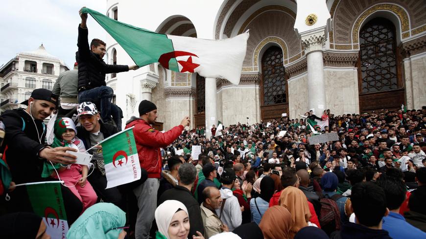 People carry national flags and banners during a protest calling on President Abdelaziz Bouteflika to quit, in Algiers, Algeria March 26, 2019. REUTERS/Ramzi Boudina - RC1FD43A5650
