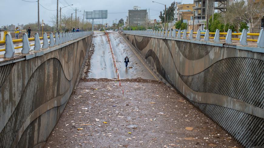 A man walks near a tunnel filled with water after a flash flooding in Shiraz, Iran, March 26, 2019. Tasnim News Agency/via REUTERS ATTENTION EDITORS - THIS PICTURE WAS PROVIDED BY A THIRD PARTY - RC14C7A3E250