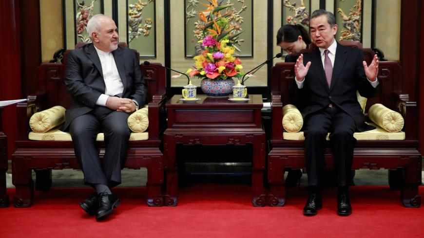 Iranian Foreign Minister Mohammad Javad Zarif (L) and his Chinese counterpart Wang Yi iduring their meeting at the Diaoyutai State Guesthouse in Beijing, China February 19, 2019. How Hwee Young/Pool via REUTERS - RC12EA87AC90