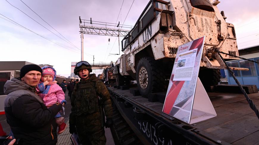 People attend a mobile exhibition installed on freight cars of a train and displaying military equipment, vehicles and weapons, which according to Russia's Defence Ministry were captured during its Syrian campaigns, upon its arrival at a railway station in Rostov-on Don, Russia February 27, 2019. REUTERS/Sergey Pivovarov - RC1F0D53CA00