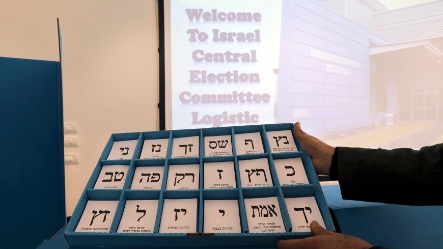 A man shows old ballot papers during a briefing for members of the media ahead of the upcoming Israeli election at the Israel Central Election Committee Logistics Center in Shoham, Israel March 6, 2019. REUTERS/Ammar Awad - RC1BEA8F8EA0